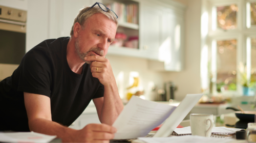 A man looks at a bill