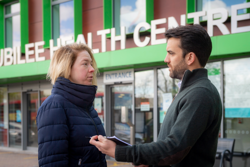 Bobby speaking to resident outside GP surgery